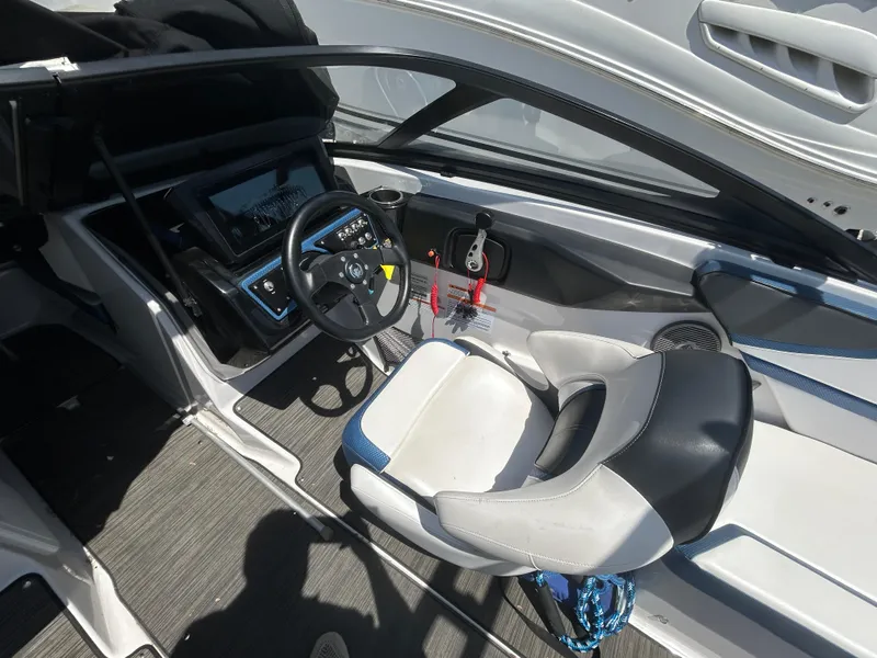Slide: The Image of 2019 Scarab 215 ID boat interior with steering wheel and seating. - 8