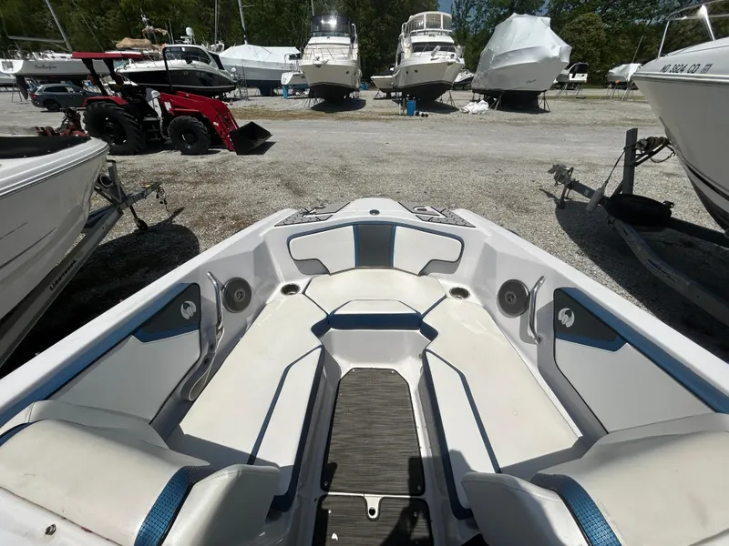 Slide: The Image of 2019 Scarab 215 ID boat interior with seating, parked among other boats. - 9