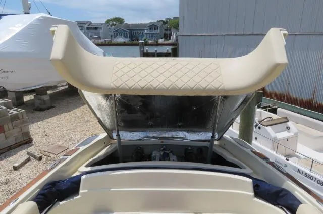 Slide: The Image of 2021 Chris-Craft Launch 27 boat with beige seating and waterfront background. - 10