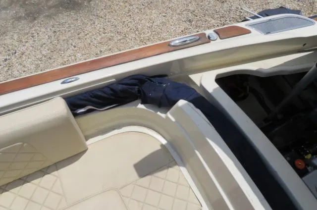 Slide: The Image of 2021 Chris-Craft Launch 27 interior with beige seating and wood accents. - 13