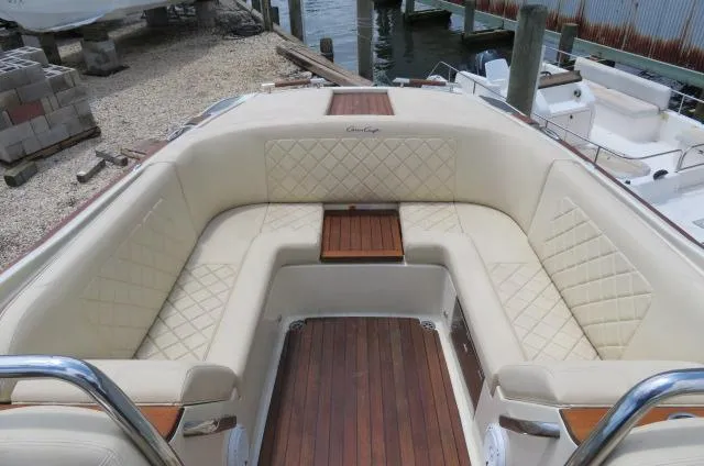 Slide: The Image of 2021 Chris-Craft Launch 27 boat interior with beige seating and wooden accents. - 15
