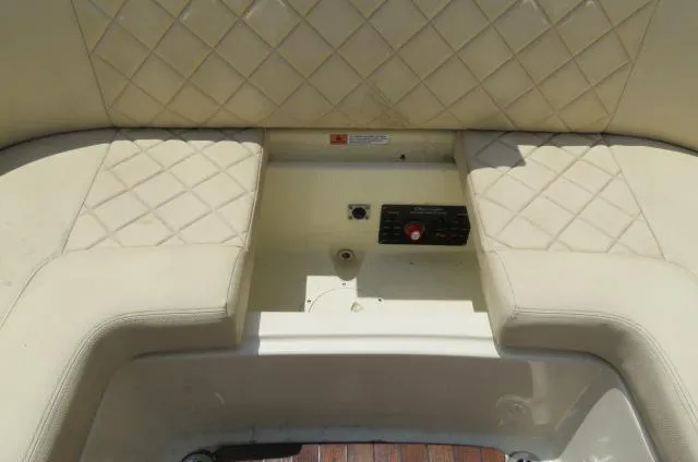 Slide: The Image of 2021 Chris-Craft Launch 27 boat interior with quilted beige seating and control panel. - 16