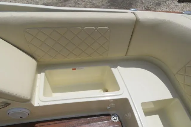 Slide: The Image of 2021 Chris-Craft Launch 27 interior with beige seating and storage compartment. - 17