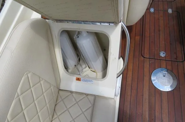 Slide: The Image of 2021 Chris-Craft Launch 27 boat seat storage with quilted upholstery and wooden deck. - 18