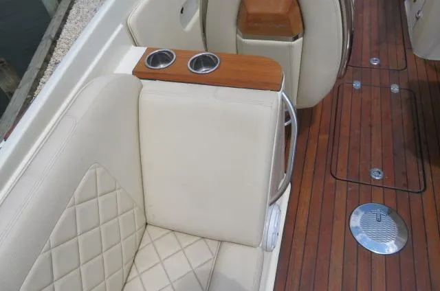 Slide: The Image of 2021 Chris-Craft Launch 27 interior with quilted seating and wooden deck. - 19