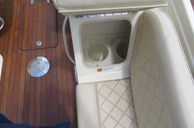 Slide: The Image of 2021 Chris-Craft Launch 27 interior with beige seating and wooden flooring. - 21