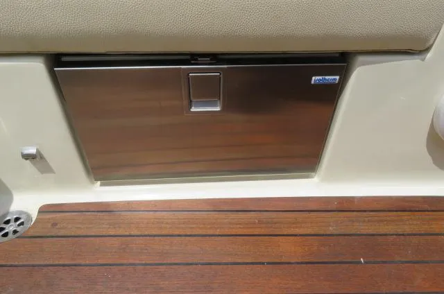 Slide: The Image of Stainless steel compartment on 2021 Chris-Craft Launch 27 boat with wooden deck. - 22