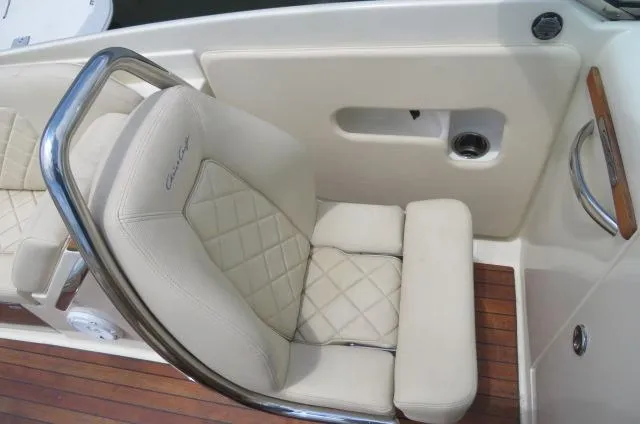 Slide: The Image of 2021 Chris-Craft Launch 27 boat seat with cream upholstery and wooden deck. - 31