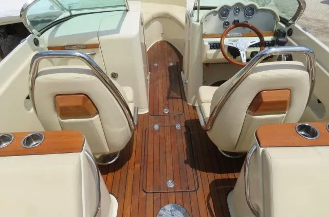 Slide: The Image of 2021 Chris-Craft Launch 27 interior with wood finish and beige seating. - 33
