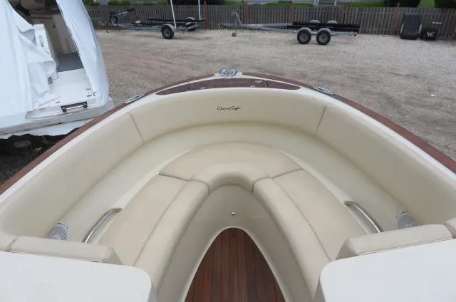 Slide: The Image of 2021 Chris-Craft Launch 27 boat with beige seating and wooden deck. - 36