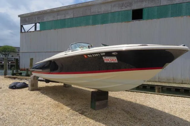 Slide: The Image of 2021 Chris-Craft Launch 27 boat for sale, displayed on blocks near a dock. - 38