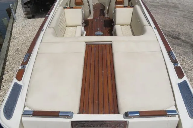 Slide: The Image of 2021 Chris-Craft Launch 27 boat interior with cream seating and wooden deck. - 8