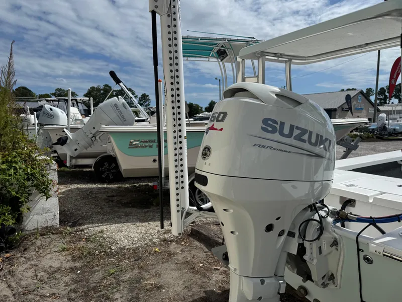 Slide: The Image of 2023 Mitzi Skiffs 17 Tournament boat with Suzuki outboard motor in a marina setting. - 5