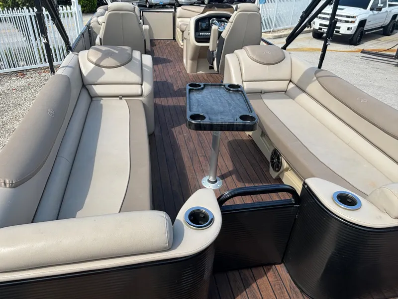Slide: The Image of 2018 Avalon Catalina Platinum Quad Lounge boat interior with beige seating and wood flooring. - 6