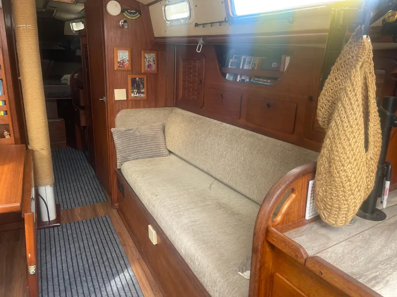 Slide: The Image of Interior of 1983 Sabre 38 Mk I Swing Keel sailboat with cozy seating and wooden finishes. - 10