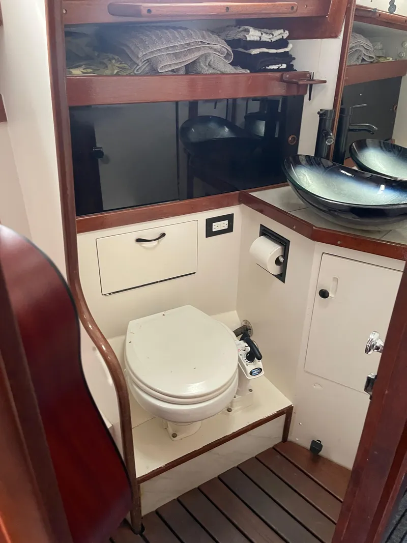Slide: The Image of 1983 Sabre 38 Mk I Swing Keel yacht bathroom with toilet and modern sink. - 17