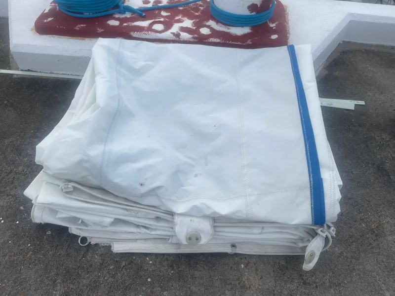 Slide: The Image of Folded white sail with blue trim from 1983 Sabre Mk I Swing Keel. - 18