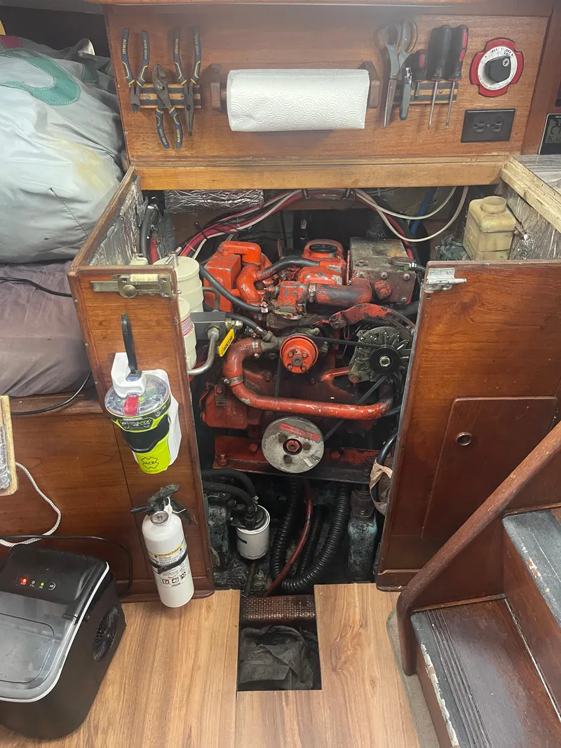 Slide: The Image of Engine compartment of a 1983 Sabre Mk I Swing Keel sailboat, showcasing mechanical components. - 19