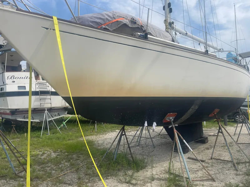 Slide: The Image of 1983 Sabre 38 Mk I Swing Keel sailboat on stands, outdoor setting. - 5
