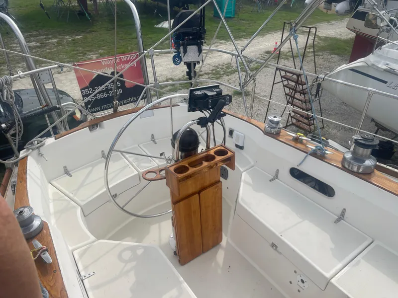 Slide: The Image of Cockpit of 1983 Sabre 38 Mk I Swing Keel sailboat with steering wheel and wooden details. - 7
