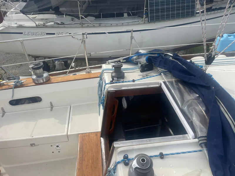Slide: The Image of 1983 Sabre 38 Mk I Swing Keel sailboat cockpit with open hatch and winches. - 8