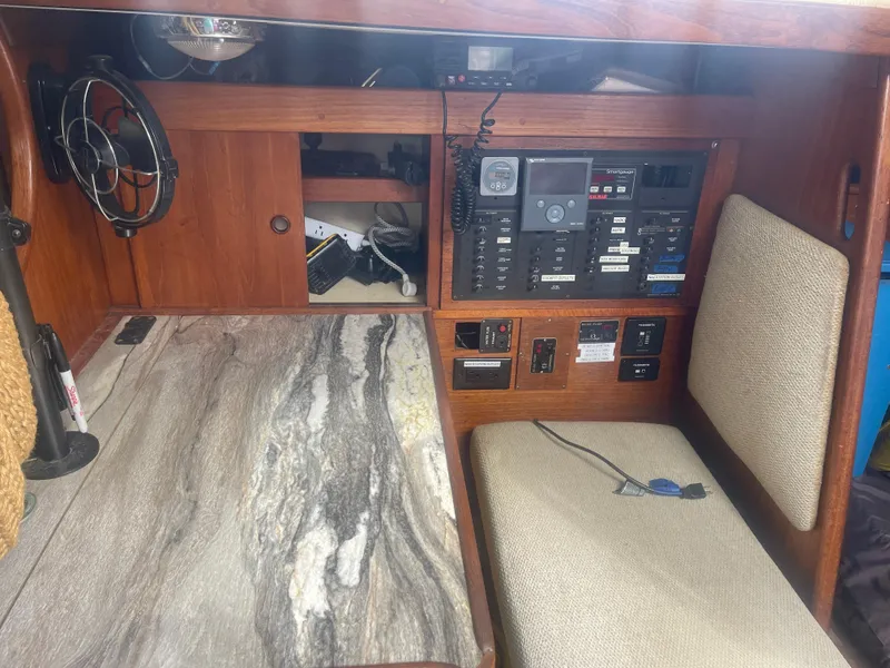 Slide: The Image of 1983 Sabre 38 Mk I Swing Keel navigation station with control panel and seating. - 9