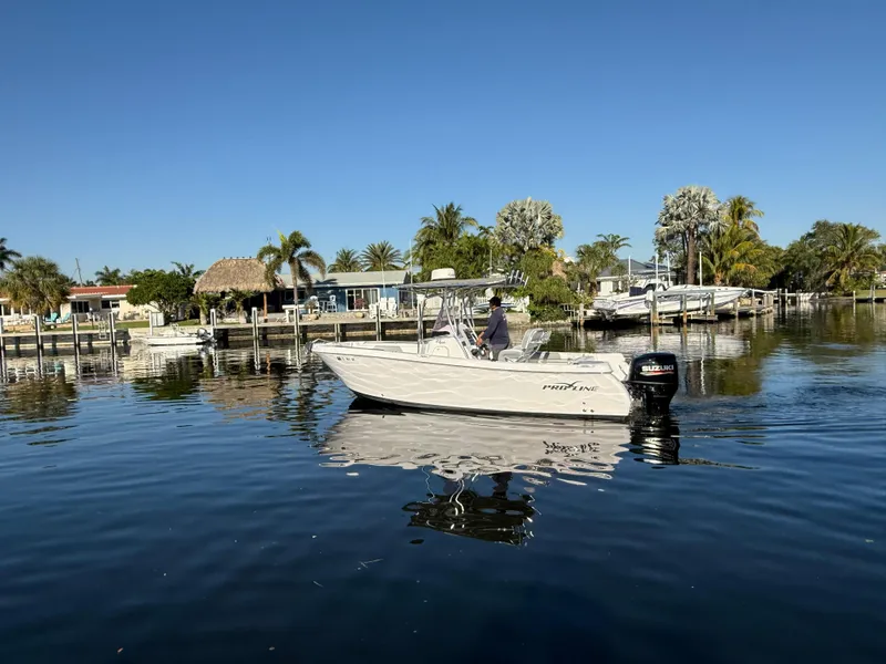 Slide: The Image of 2019 Pro-Line 23 Sport boat on calm water near a tropical shoreline. - 10