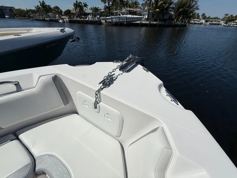 Slide: The Image of 2019 Pro-Line 23 Sport boat bow with anchor chain on calm water. - 12
