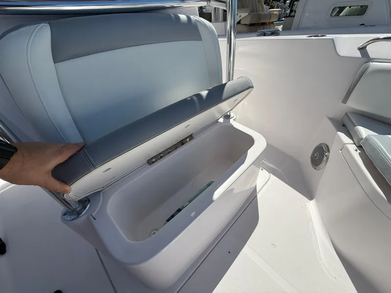 Slide: The Image of 2019 Pro-Line 23 Sport boat seat with storage compartment open. - 16
