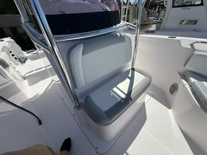 Slide: The Image of 2019 Pro-Line 23 Sport boat interior with cushioned seating and sleek design. - 17