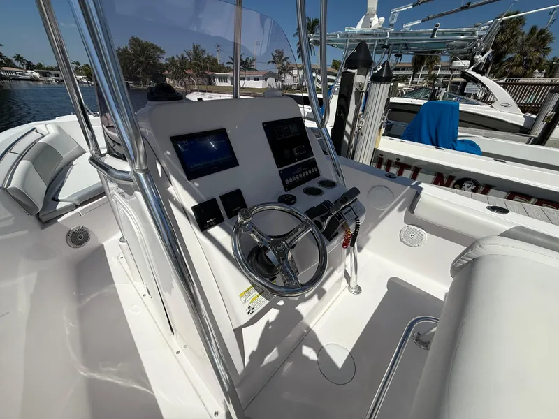 Slide: The Image of 2019 Pro-Line 23 Sport boat console with steering wheel and controls. - 23