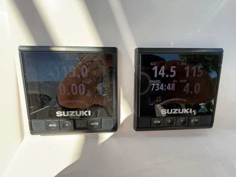 Slide: The Image of Suzuki digital displays on 2019 Pro-Line 23 Sport boat dashboard. - 25