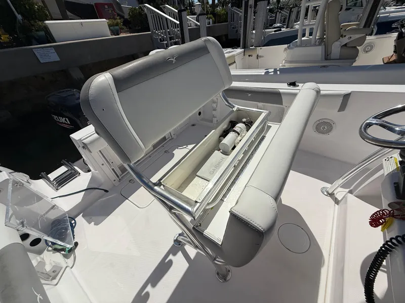 Slide: The Image of 2019 Pro-Line 23 Sport boat interior with open storage compartment and seating. - 30