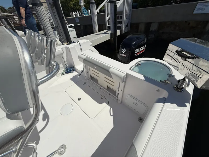 Slide: The Image of 2019 Pro-Line 23 Sport boat interior with Suzuki outboard motor at dock. - 32
