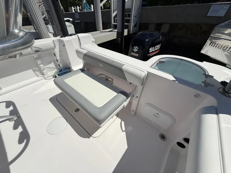 Slide: The Image of 2019 Pro-Line 23 Sport boat interior with seating and Suzuki outboard motor. - 34