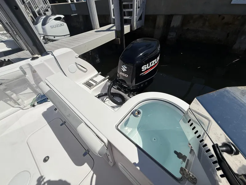 Slide: The Image of 2019 Pro-Line 23 Sport boat with Suzuki outboard motor at dock. - 35