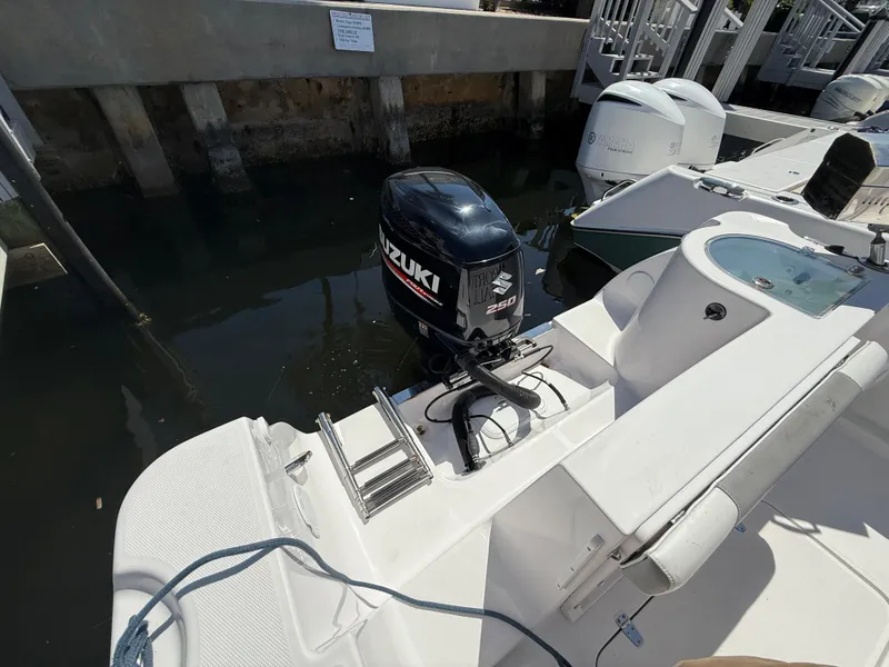 Slide: The Image of 2019 Pro-Line 23 Sport boat with Suzuki outboard motor docked in marina. - 36