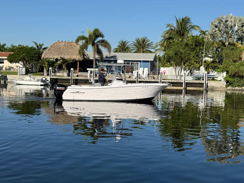 Slide: The Image of 2019 Pro-Line 23 Sport boat on calm water near a tropical dock. - 4
