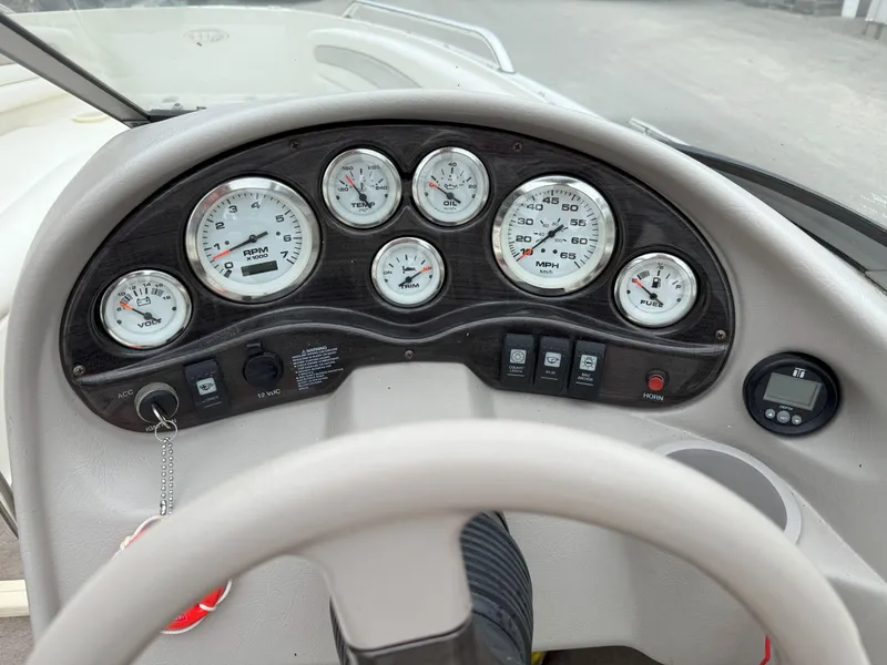 Slide: The Image of Dashboard of a 2003 Stingray 200LX boat with gauges and controls. - 10