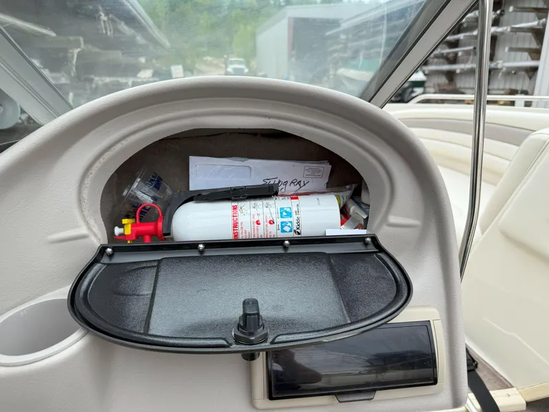 Slide: The Image of 2003 Stingray 200LX boat dashboard storage with fire extinguisher and documents. - 11