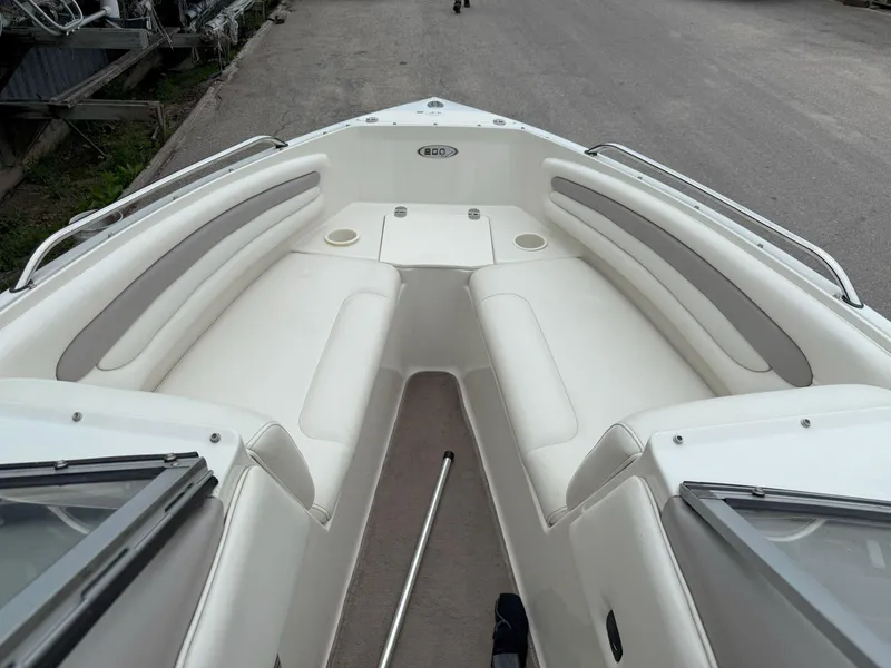 Slide: The Image of 2003 Stingray 200LX boat interior with white seating and open bow design. - 16