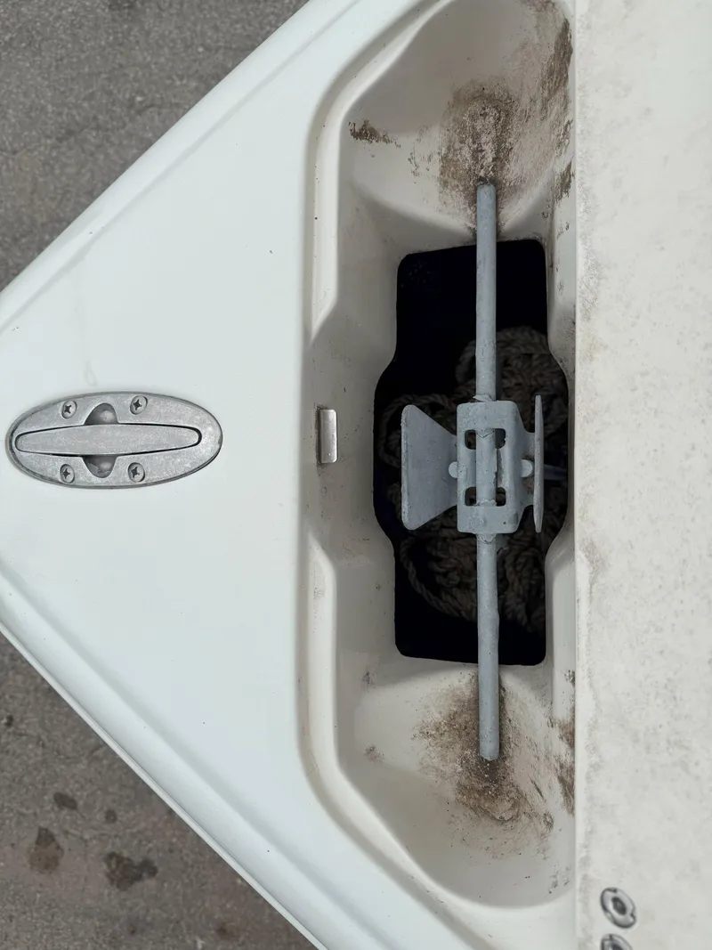 Slide: The Image of Anchor compartment of 2003 Stingray 200LX boat with visible anchor and latch. - 22