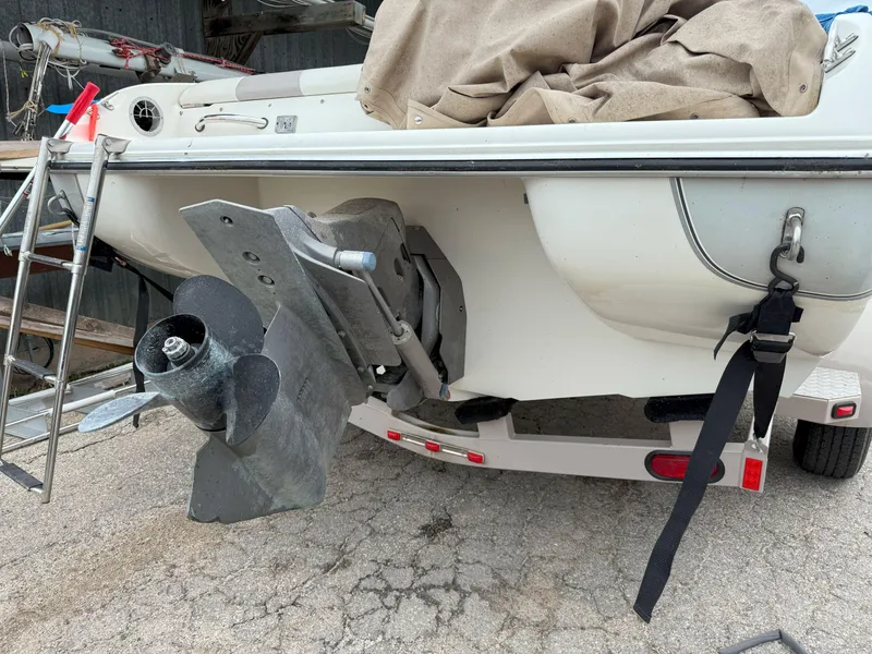 Slide: The Image of 2003 Stingray 200LX boat on trailer, showing propeller and ladder. - 4