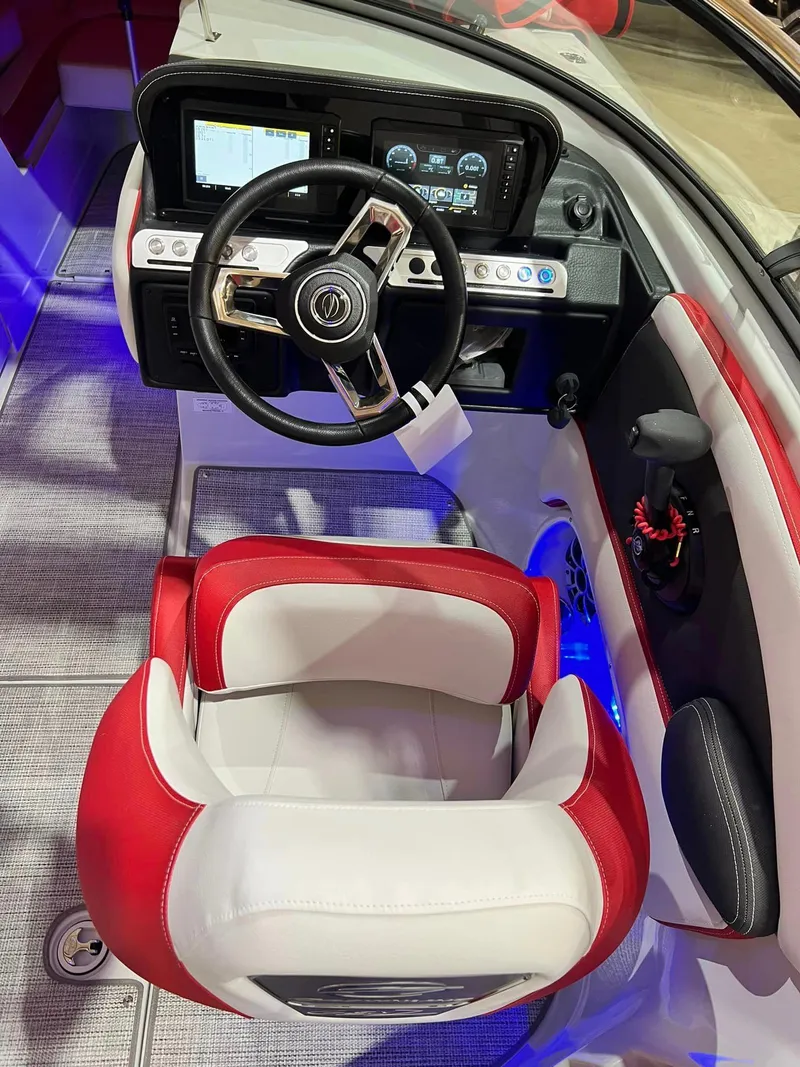 Slide: The Image of 2024 Crownline 250XSS boat cockpit with red and white seating, modern dashboard, and steering wheel. - 10