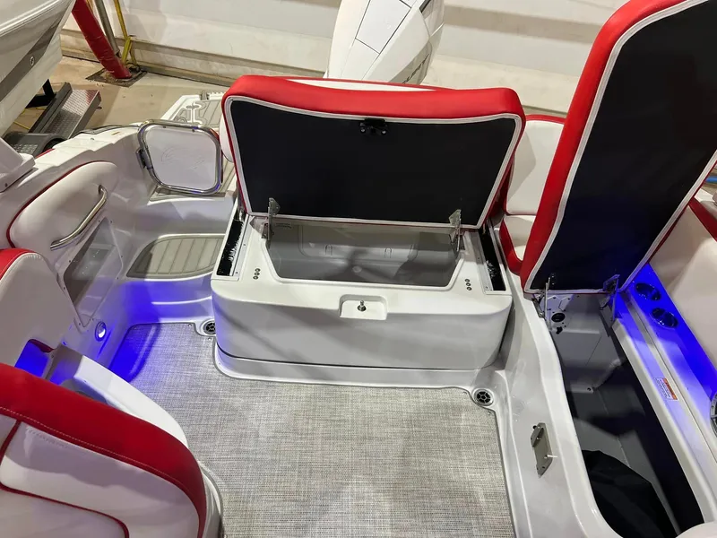 Slide: The Image of 2024 Crownline 250XSS boat interior with open storage compartment and red accents. - 3