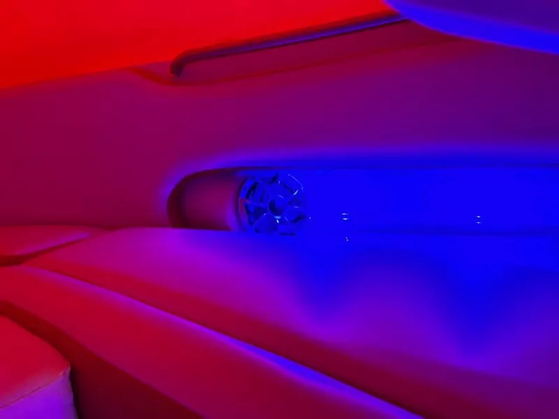 Slide: The Image of 2024 Crownline 250XSS interior with vibrant red and blue LED lighting. - 6