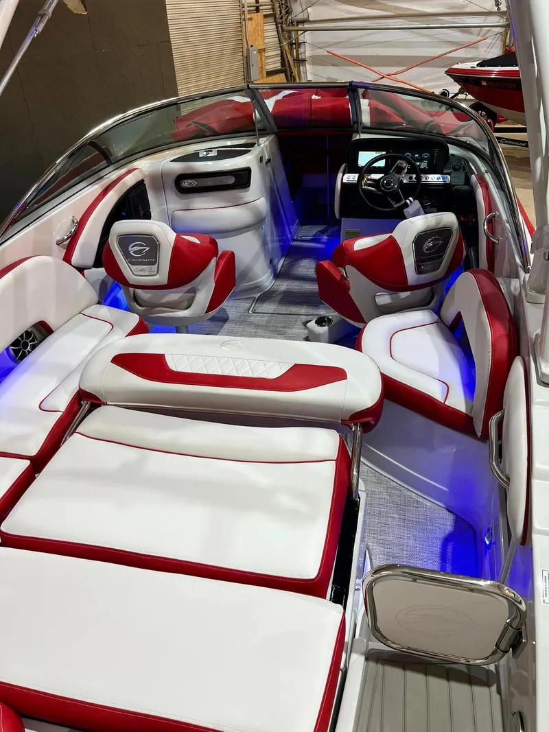 Slide: The Image of 2024 Crownline 250XSS boat interior with red and white seating, illuminated accents, and modern dashboard. - 8