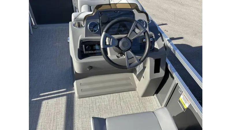 Slide: The Image of 2025 Tahoe Pontoon 19 Quad Lounge Sport steering console with modern controls and seating. - 3
