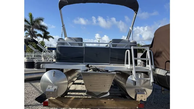 Slide: The Image of 2025 Tahoe Pontoon 19 Quad Lounge Sport with canopy, docked under clear blue sky. - 5