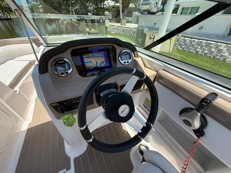 Slide: The Image of 2021 Chaparral 23 SSi OB boat dashboard with steering wheel and navigation display. - 11